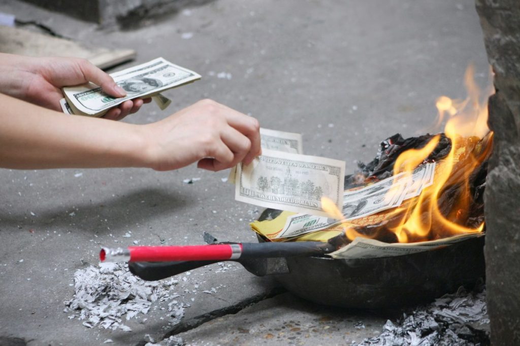 Burning votive paper (ghost money) for the death