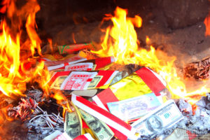 Votive paper offerings are burned to send to the death