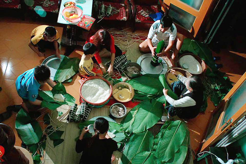 Family gathering to make Banh Tet, a traditional food in the Vietnamese lunar new year